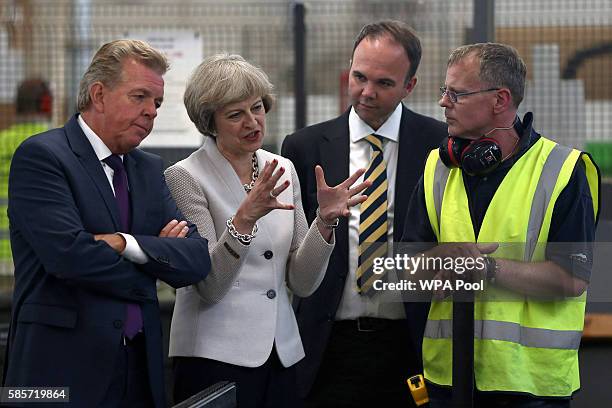 British Prime Minister Theresa May, Martek Managing Director Derek Galloway and Croydon Central MP Gavin Barwell speak with a worker as they visit...