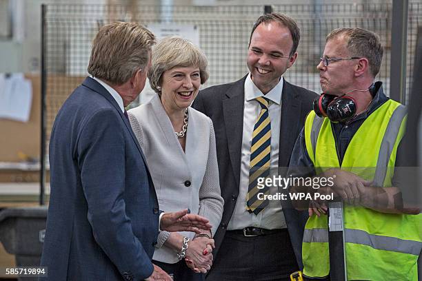 British Prime Minister Theresa May, Martek Managing Director Derek Galloway and Croydon Central MP Gavin Barwell speak with a worker as they visit...