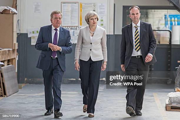 British Prime Minister Theresa May walks with Martek Managing Director Derek Galloway and Croydon Central MP Gavin Barwell during a visit to Martinek...