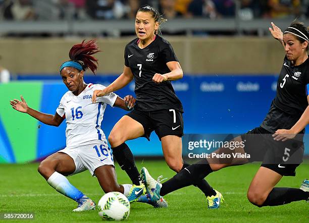 Crystal Dunn of United States battles for the ball against Ali Riley and Abby Erceg of New Zealand in the Women's Group G first round match between...