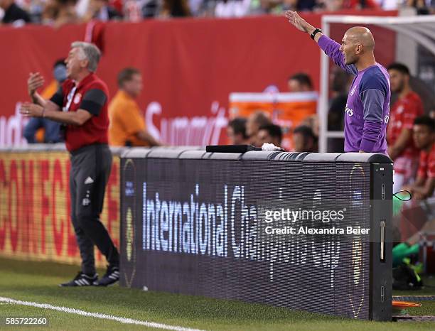 Team coach Carlo Ancelotti of Bayern Muenchen and team coach Zinedine Zidane of Real Madrid react during the International Champions Cup match...