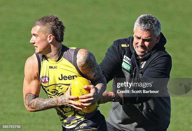Dustin Martin of the Tigers is tackled by Mark Williams, Tigers Senior Development Coach during a Richmond Tigers AFL training session at Punt Road...