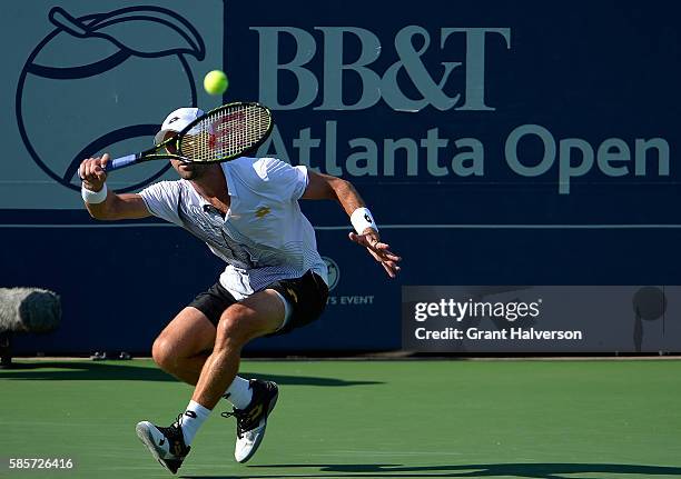 Tim Smyczek of the Unites States returns a shot to Donald Young of the United States during the BB&T Atlanta Open at Atlantic Station on August 3,...
