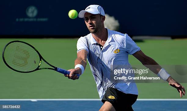 Tim Smyczek of the Unites States returns a shot to Donald Young of the United States during the BB&T Atlanta Open at Atlantic Station on August 3,...