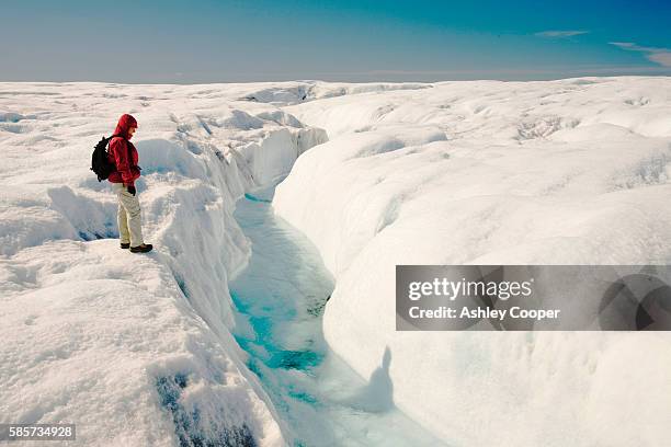 melt water on the greenland ice sheet near camp victor north of ilulissat. the greenland ice sheet is the largest ice sheet outside of antarctica. temperatues have risen by nine degrees fahrenheit in greenland in the last 60 years due to human induced cli - crevasse fotografías e imágenes de stock