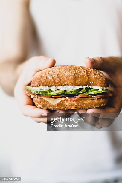 sandwich in hands - sandwich stock-fotos und bilder