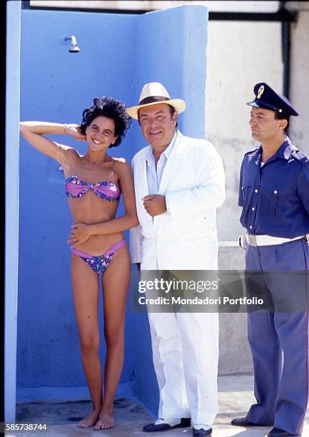 Italian comedian Lino Banfi posing on the set of the film "Il commissario Lo Gatto" with Italian actress Valeria Milillo playing Manuela Belluggi and...