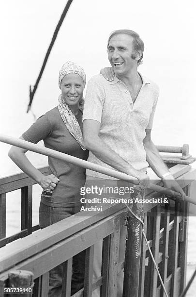 Italian TV host Pippo Baudo on holiday with his first wife Angela Lippi on a Roman coast beach. In the picture: the couple posing smiling on a jetty...