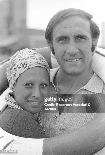 Italian TV host Pippo Baudo on holiday with his first wife Angela Lippi on a Roman coast beach. In the picture: the couple hugging with a life...