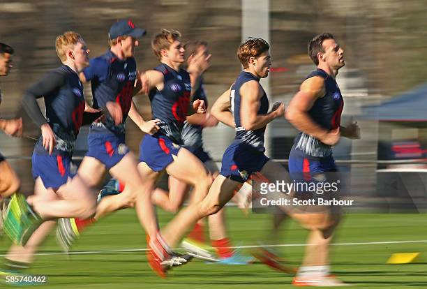 Clayton Oliver, Jack Viney and Cameron Pedersen of the Demons run during a Melbourne Demons AFL training session at Gosch's Paddock on August 4, 2016...