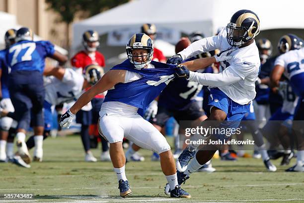 Chase Reynolds of the Los Angeles Rams tries to break free from Nic Grigsby during afternoon practice on August 3, 2016 in Irvine, California.