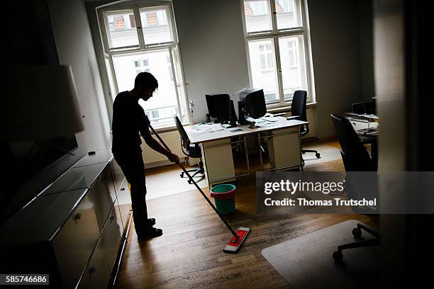Berlin, Germany Symbolic photo to the topic moonlighting. A man cleans an office on August 04, 2016 in Berlin, Germany.