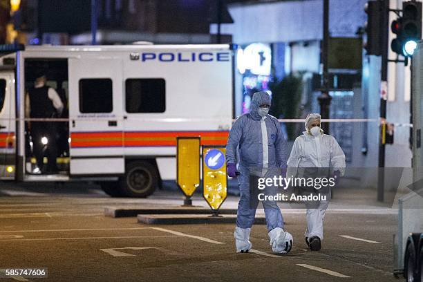 Forensic police officers investigate a mass stabbing incident, which left one woman dead and up to six people injured outside the Imperial Hotel at...