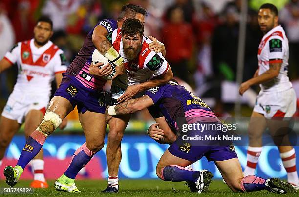 Will Matthews of the Dragons is tackled during the round 22 NRL match between the St George Illawarra Dragons and the Brisbane Bronocs at WIN Stadium...