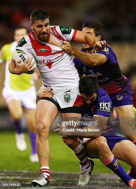 Tyrone McCarthy of the Dragons is tackled during the round 22 NRL match between the St George Illawarra Dragons and the Brisbane Bronocs at WIN...