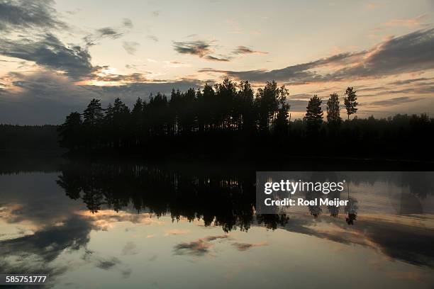 evening sky and trees mirroring in swedish lake - dalsland stock pictures, royalty-free photos & images