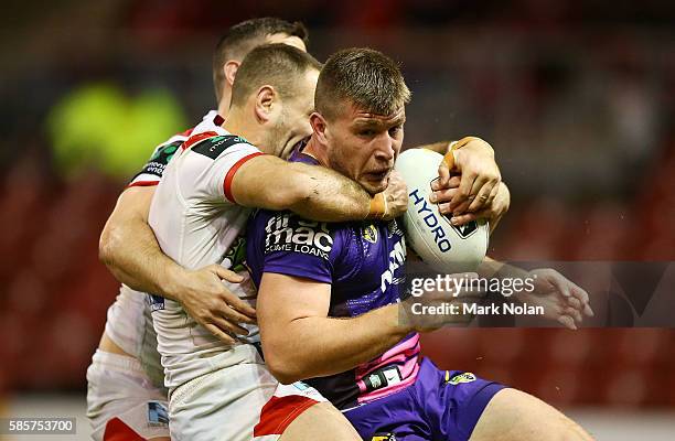 Jacob Host of the Dragons is tackled during the round 22 NRL match between the St George Illawarra Dragons and the Brisbane Bronocs at WIN Stadium on...