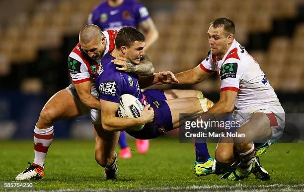 Corey Oates of the Broncos is tackled during the round 22 NRL match between the St George Illawarra Dragons and the Brisbane Bronocs at WIN Stadium...