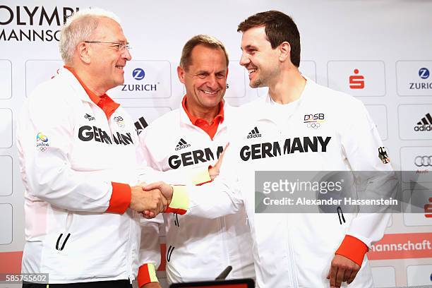 Michael Vesper , CEO of the German Olympic Sports Confederation and Alfons Hoermann, German Olympic Association president shake hands with table...