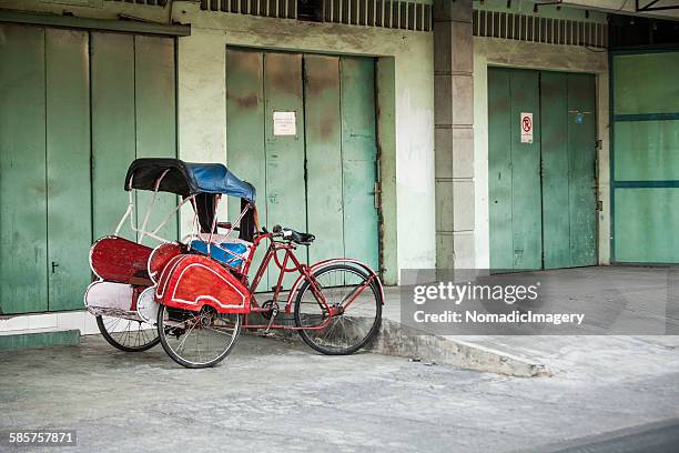 red indonesian becak - three wheeled pushchair stock pictures, royalty-free photos & images