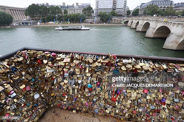 Love-locks are seen on the bridge of Pont Neuf in Paris, on August 4, 2016. Love may know no bounds, but Paris intends to instill some: authorities...