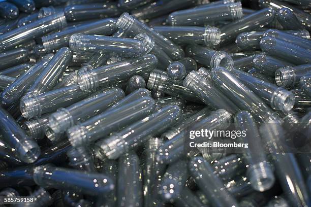 Unshaped one liter soft drink bottles sit in a bin before molding at the Coca-Cola Co. Factory in Dongen, Netherlands, on Thursday, Aug. 4, 2016....