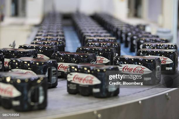 Sealed six packs of Coke Zero sugar free soft drink cans move along a conveyor following manufacture at the Coca-Cola Co. Factory in Dongen,...