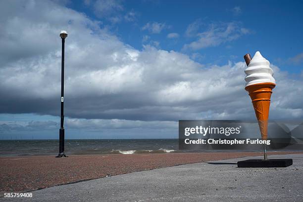 Plastic ice cream cone lures holidaymakers to a cafe on the promenade of Rhyl seaside resort on August 3, 2016 in Rhyl, Wales. British seaside...