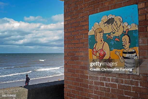 Weather beaten sign warns of the danger of seagulls stealing ice creams on the promenade of Rhyl seaside resort on August 3, 2016 in Rhyl, Wales....