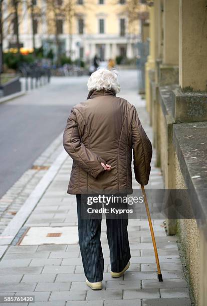 germany, bavaria, regensburg, view of elderly woman with walking stick - old person with walking stick outside standing stock pictures, royalty-free photos & images