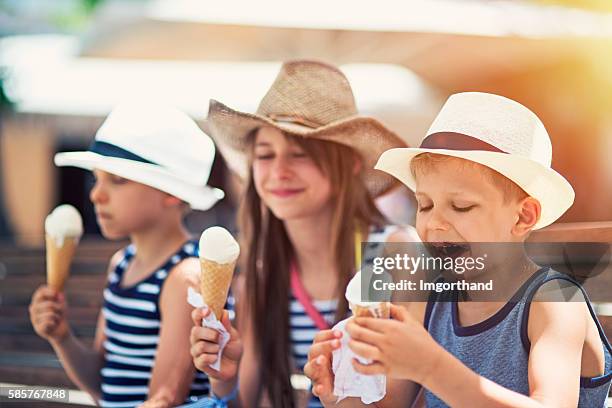 kids tourists eating ice cream - child eating ice cream stock pictures, royalty-free photos & images