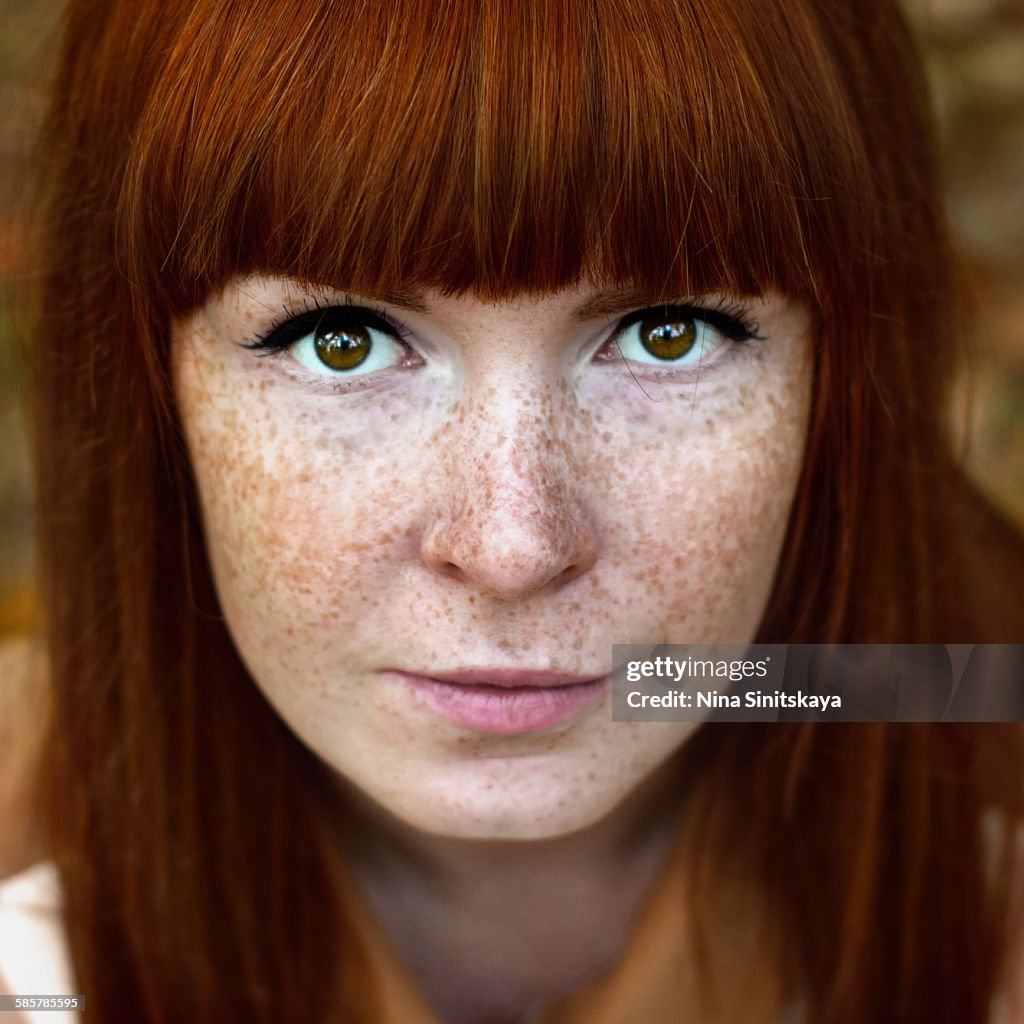 Face shot of beautiful red woman with freckles