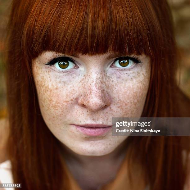 Face shot of beautiful red woman with freckles