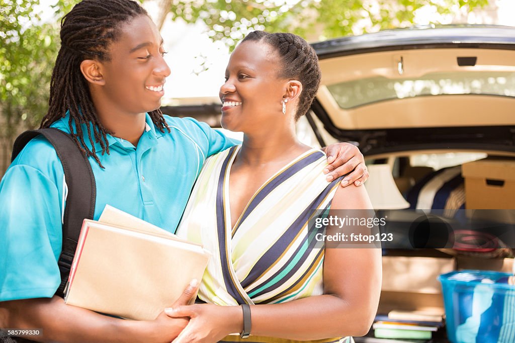 African-descent boy moves off to college and hugs mom goodbye.