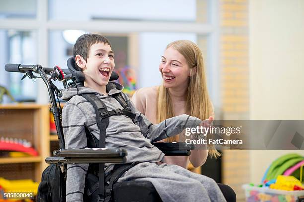 bond between caregiver and patient - wheelchair stockfoto's en -beelden