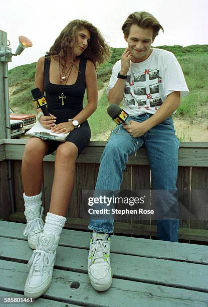 Host Daisy Fuentes with actor Christian Slater during the filming of Beach MTV at the Beachcomber in Wellfleet, Massachusetts, 29th July 1990.