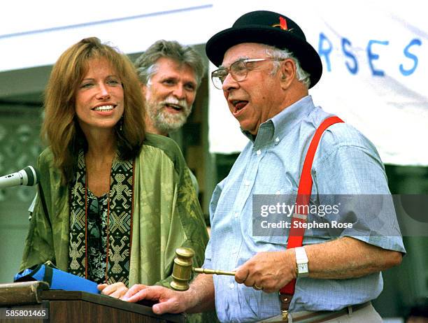 Writer Art Buchwald and singer Carly Simon auction an 8-mile cycling tour of Gay Head with John F. Kennedy Jr. At the Possible Dreams Auction in...