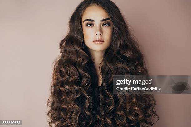 studio shot of young beautiful woman - curly hair stock pictures, royalty-free photos & images