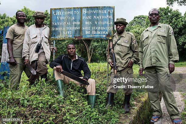 Group of rangers pause in front of a field post that is a starting base for a visit to mountain gorillas. The Virunga park, created in 1925 under the...