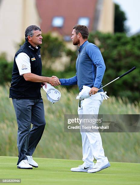 Paul Lawrie of Scotland is congratulated after winning his match against Lucas Bjerregaard of Denmark on day one of the Aberdeen Asset Management...