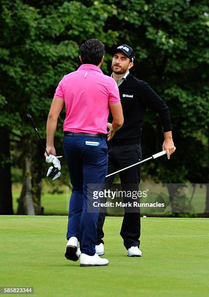 Alejandro Canizares of Spain is congratulated by Mike Lorenzo-Vera of France after winning on the first playoff hole on day one of the Aberdeen Asset...
