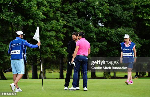Alejandro Canizares of Spain is congratulated by Mike Lorenzo-Vera of France after winning on the first playoff hole on day one of the Aberdeen Asset...
