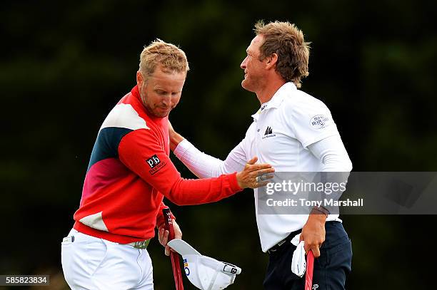 Matt Ford of England shakes hands with Pelle Edberg of Sweden after winning their match on the green at hole 16 on day one of the Aberdeen Asset...