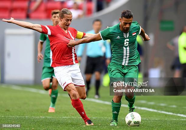 Iraq player Ali Adnan vies for the ball with Denmark player Lasse Vibe during their Rio 2016 Olympic Games First Round Group A men's football match...