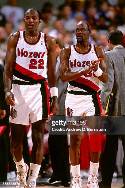 Clyde Drexler and Terry Porter of the Portland Trail Blazers walk on the court during a game circa 1991 in Portland, Oregon at Memorial Coliseum....