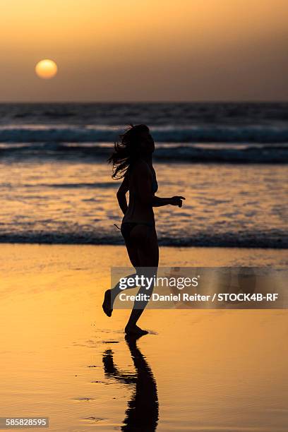 woman running on the beach at sunset, essaouira, morocco - travel african sunset rf photos only stock pictures, royalty-free photos & images