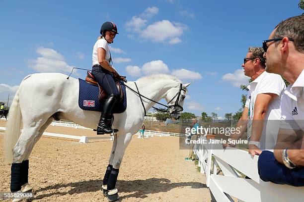 Pippa Funnell of Great Britain abord Billy The Biz talks with team members Carl Hester and Spencer Wilton during an Equestrian training session ahead...