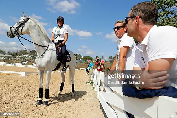 Pippa Funnell of Great Britain abord Billy The Biz talks with team members Carl Hester and Spencer Wilton during an Equestrian training session ahead...