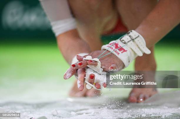 Detail as a Russian gymnast applies chalk during an artistic gymnastics training session on August 4, 2016 at the Arena Olimpica do Rio in Rio de...