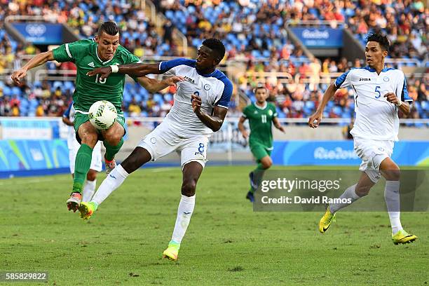 Ben Tahar Meziane of Algeria collides with Johnny Palacios of Honduras during the Men's Group D first round match between Honduras and Algeria during...